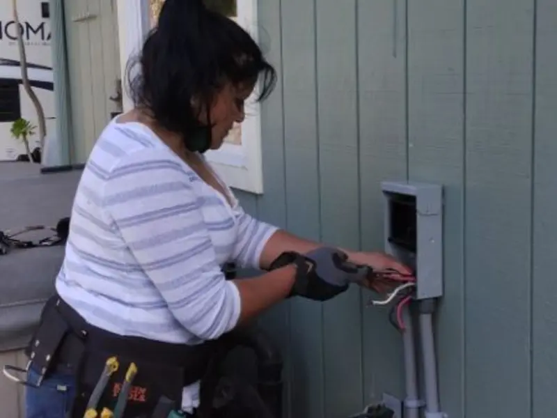 Licensed electrician wiring an exterior subpanel in Kaufman